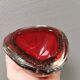 Small glass bowl in beautiful emerald red color with inlaid bubbles.
