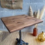 Bistro table with central cast iron leg and rustic top