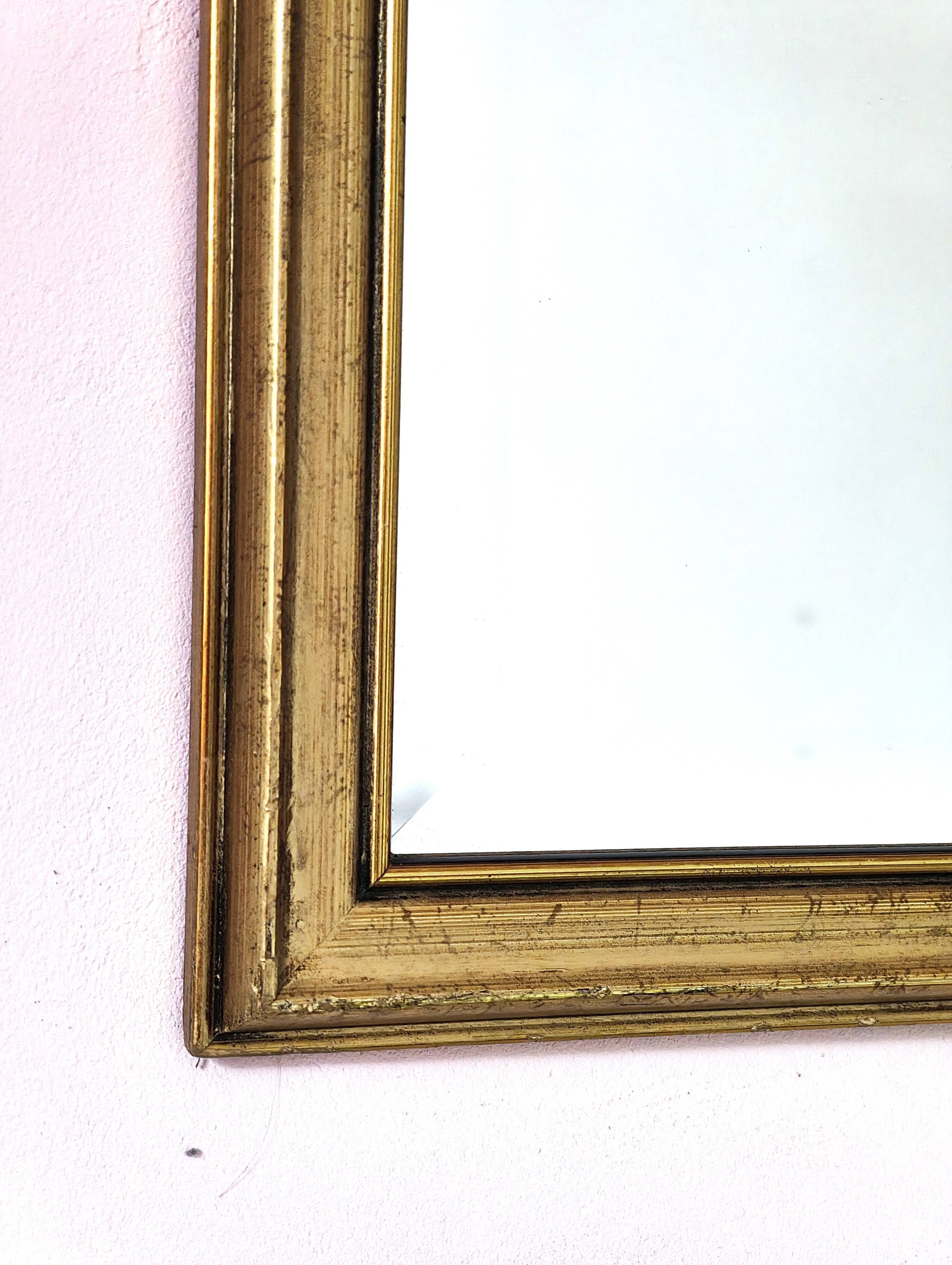 Rectangular gold mirror with bevelled glass.