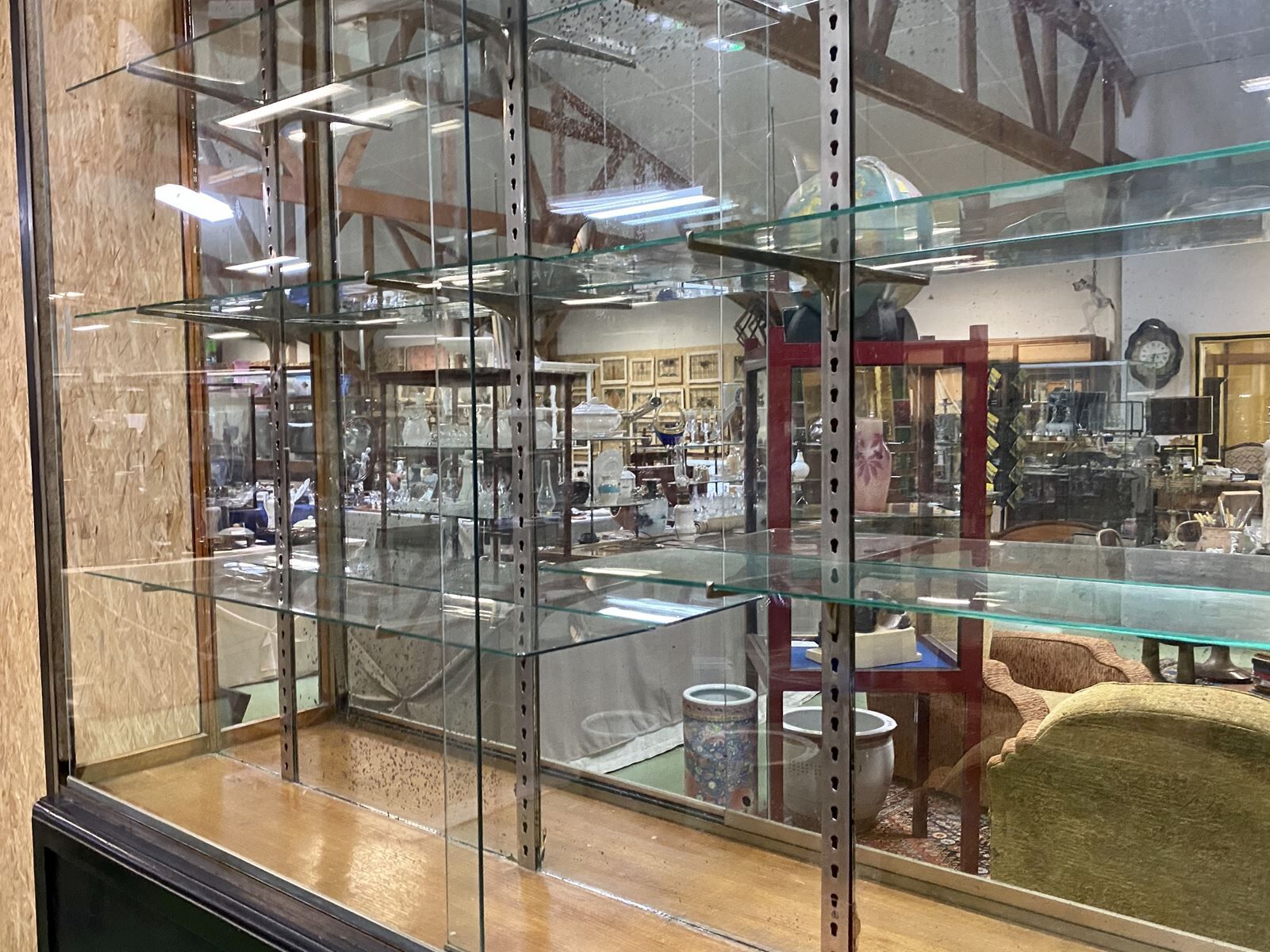 Store window with sliding doors in matte black patinated oak - 30s