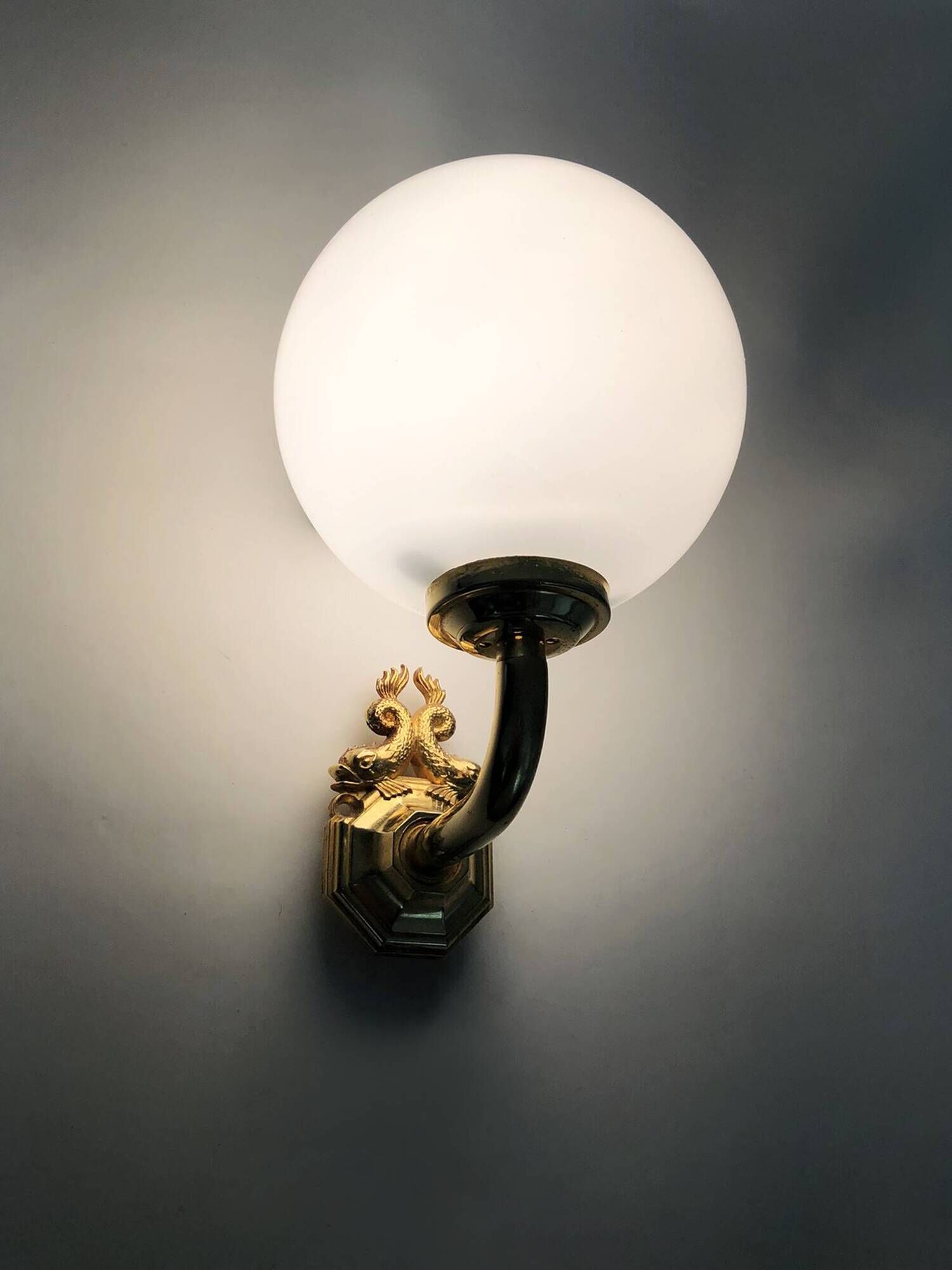 Pair of wall sconces with carp fish, brass and opaline globe.