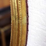 Golden oval mirror with leaf