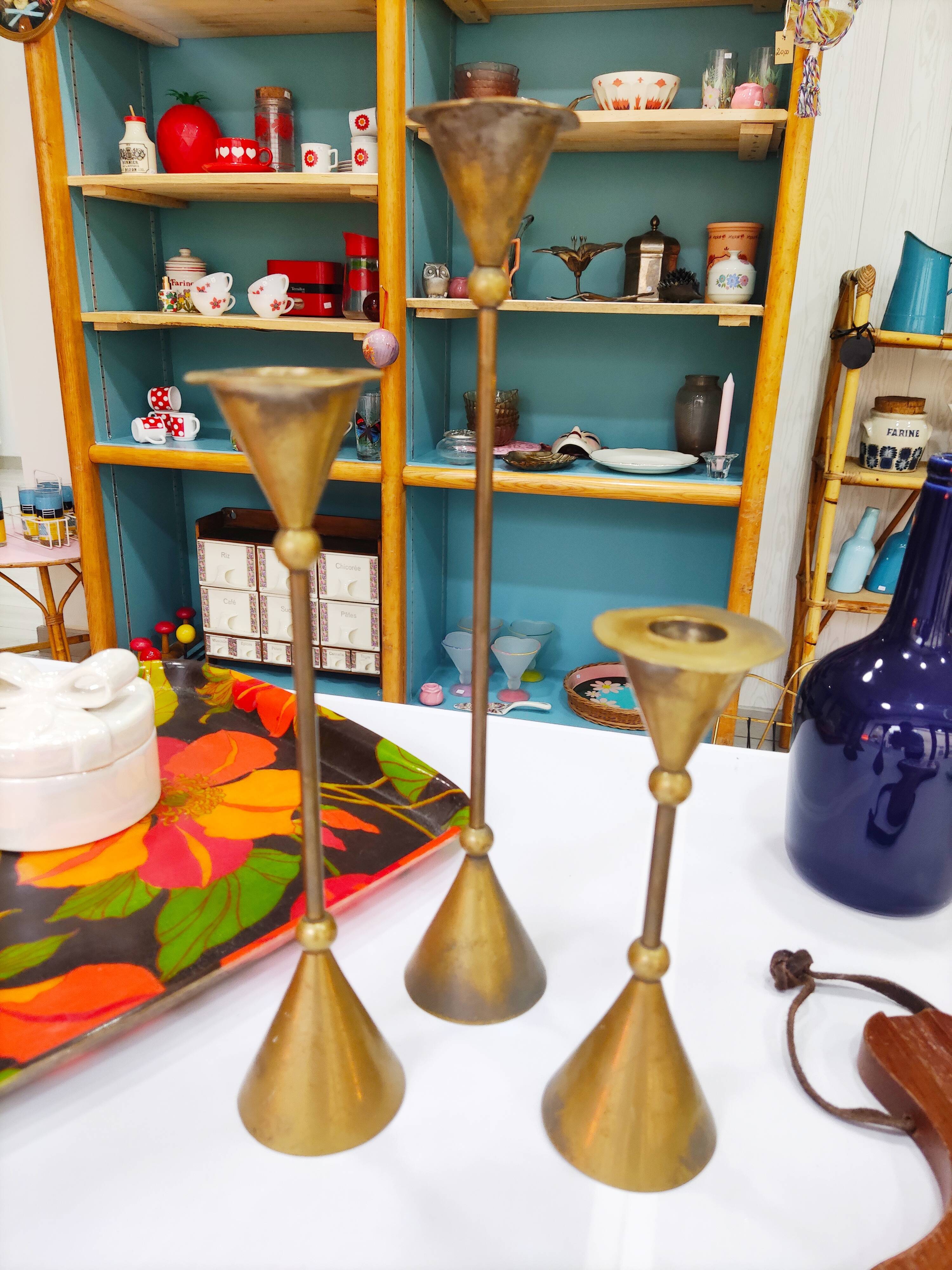 Trio of brass candlesticks design year 70