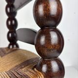 Brutalist wood turned bobbin low rush chair n the style of Charles Dudouyt