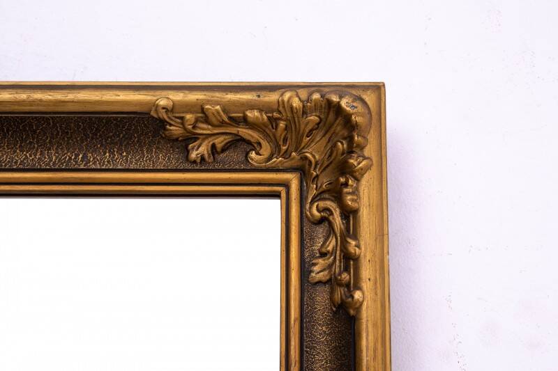 Mirror in a decorative gold frame, 63.5 x 54 cm
