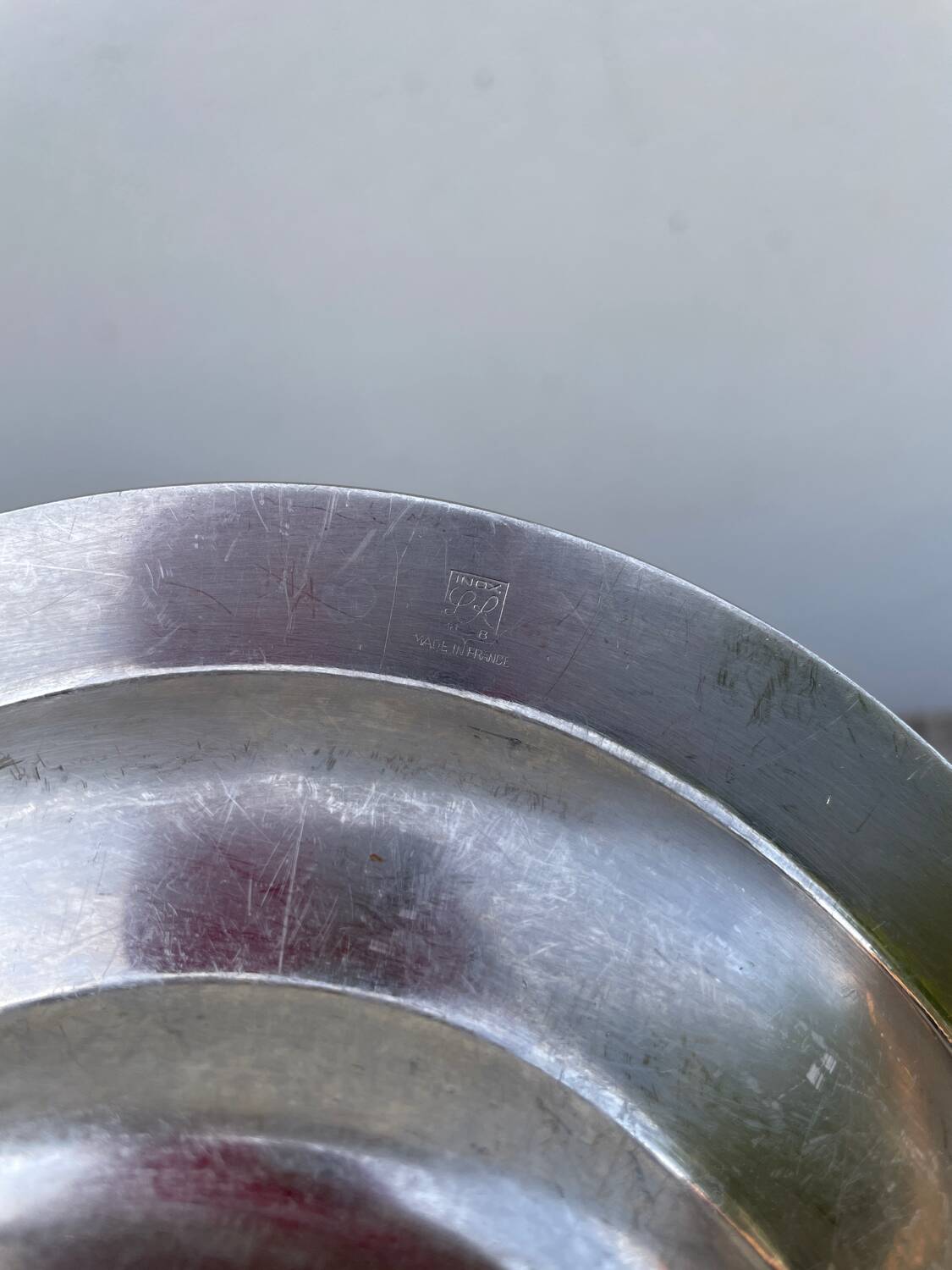 Oval stainless steel dish, signed Rémi Letang