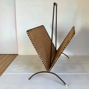 Old magazine rack in straw and black metal