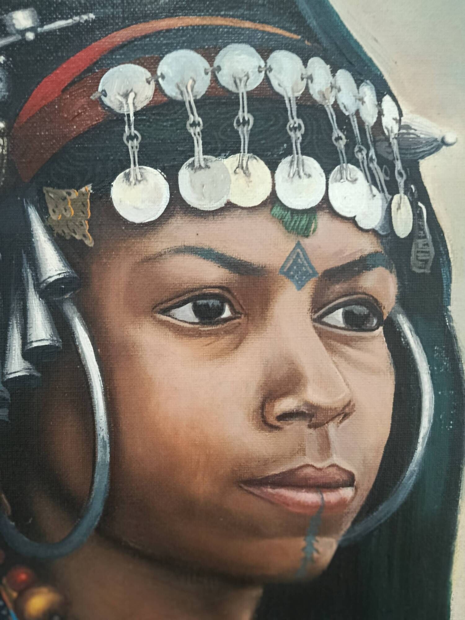 Portrait of a young Moroccan woman in traditional attire and adornments.