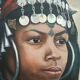 Portrait of a young Moroccan woman in traditional attire and adornments.