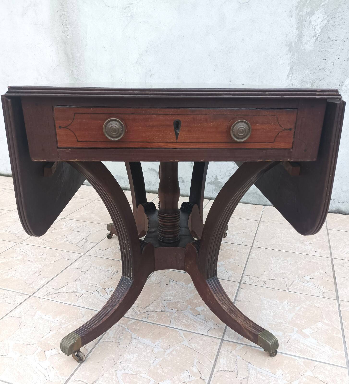 19th-century English style mahogany drop-leaf table.