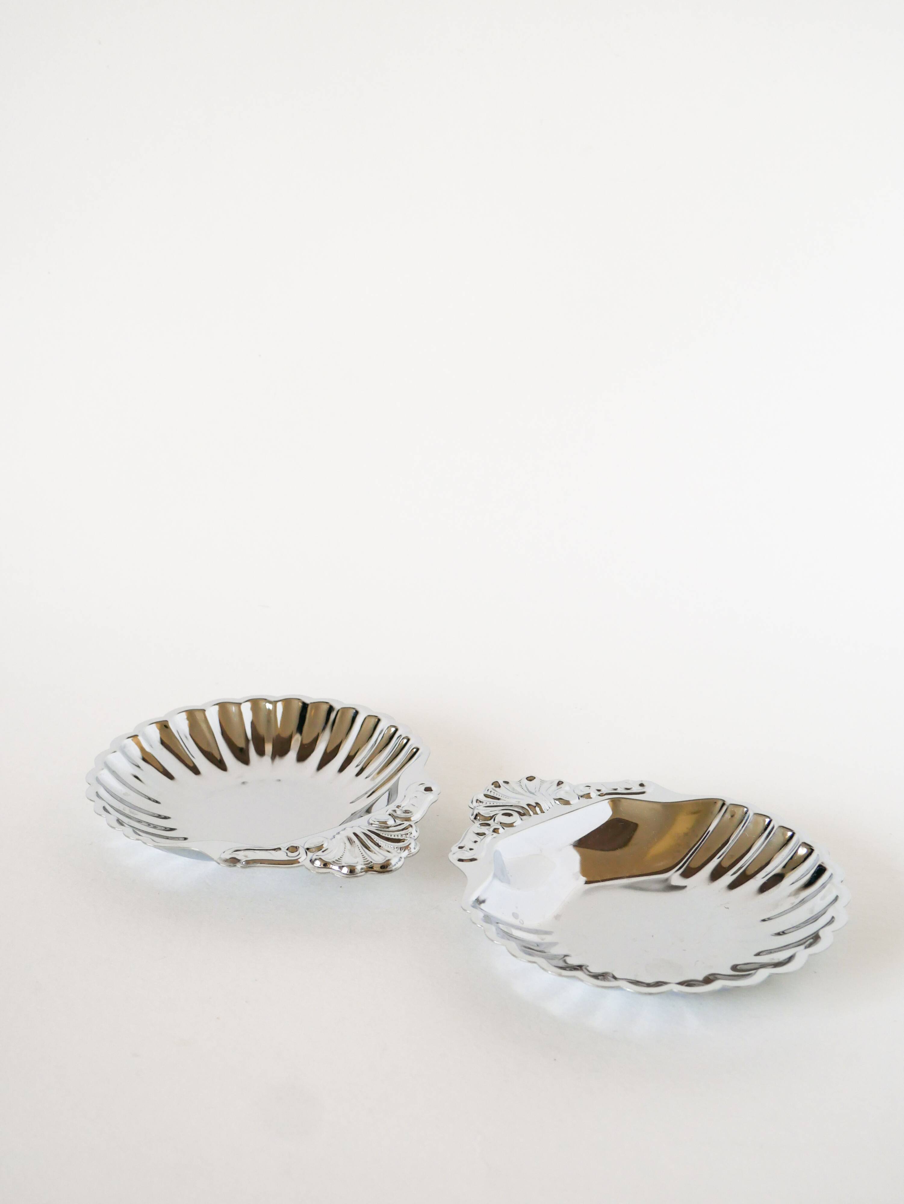Pair of worked stainless steel shell trinket trays, 1970