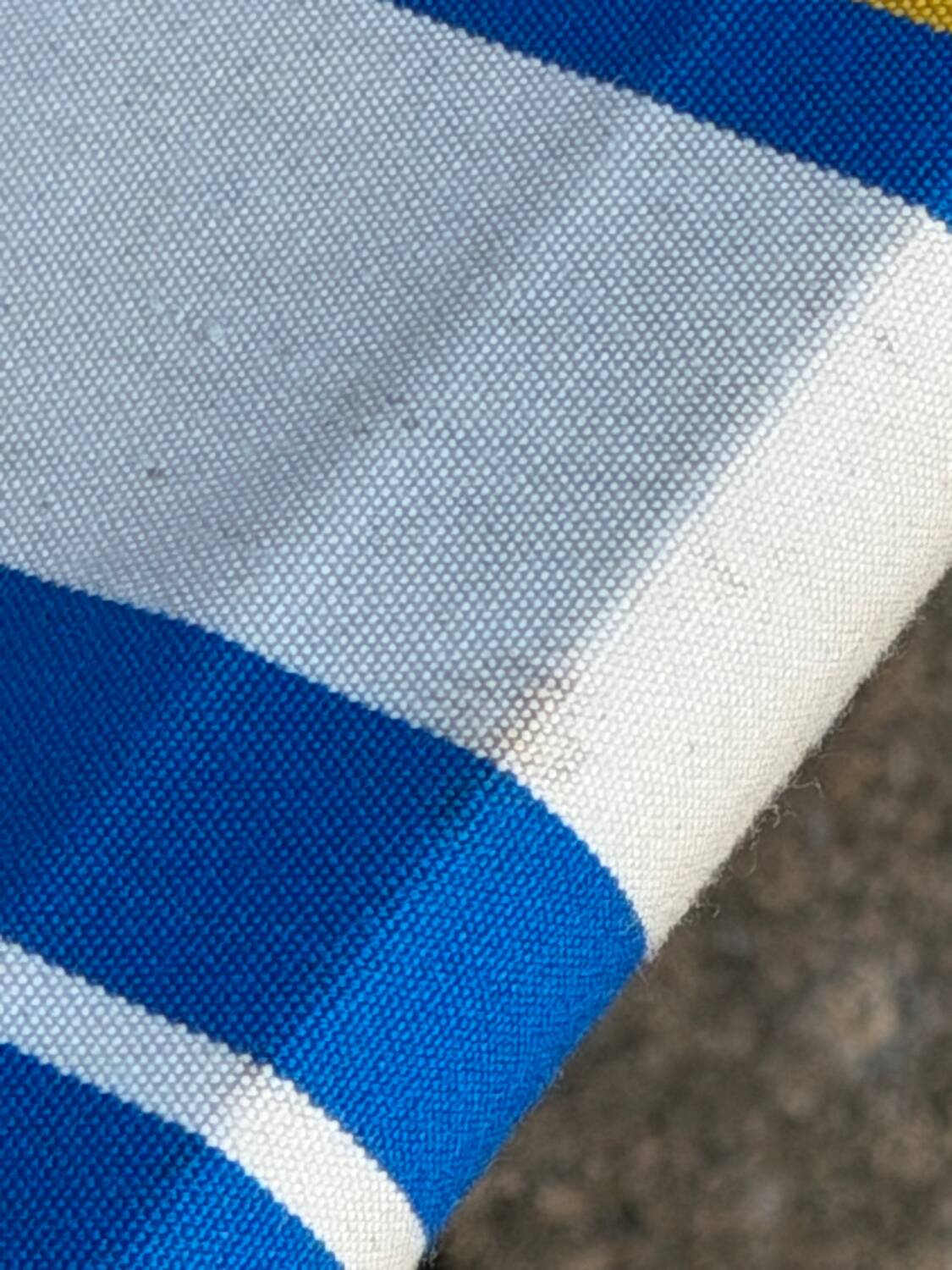 Vintage deck chair with blue and yellow striped fabric, original patina.
