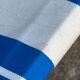 Vintage deck chair with blue and yellow striped fabric, original patina.
