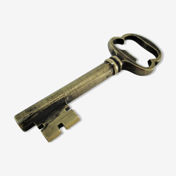 Patinated brass bottle opener cork in the shape of a key