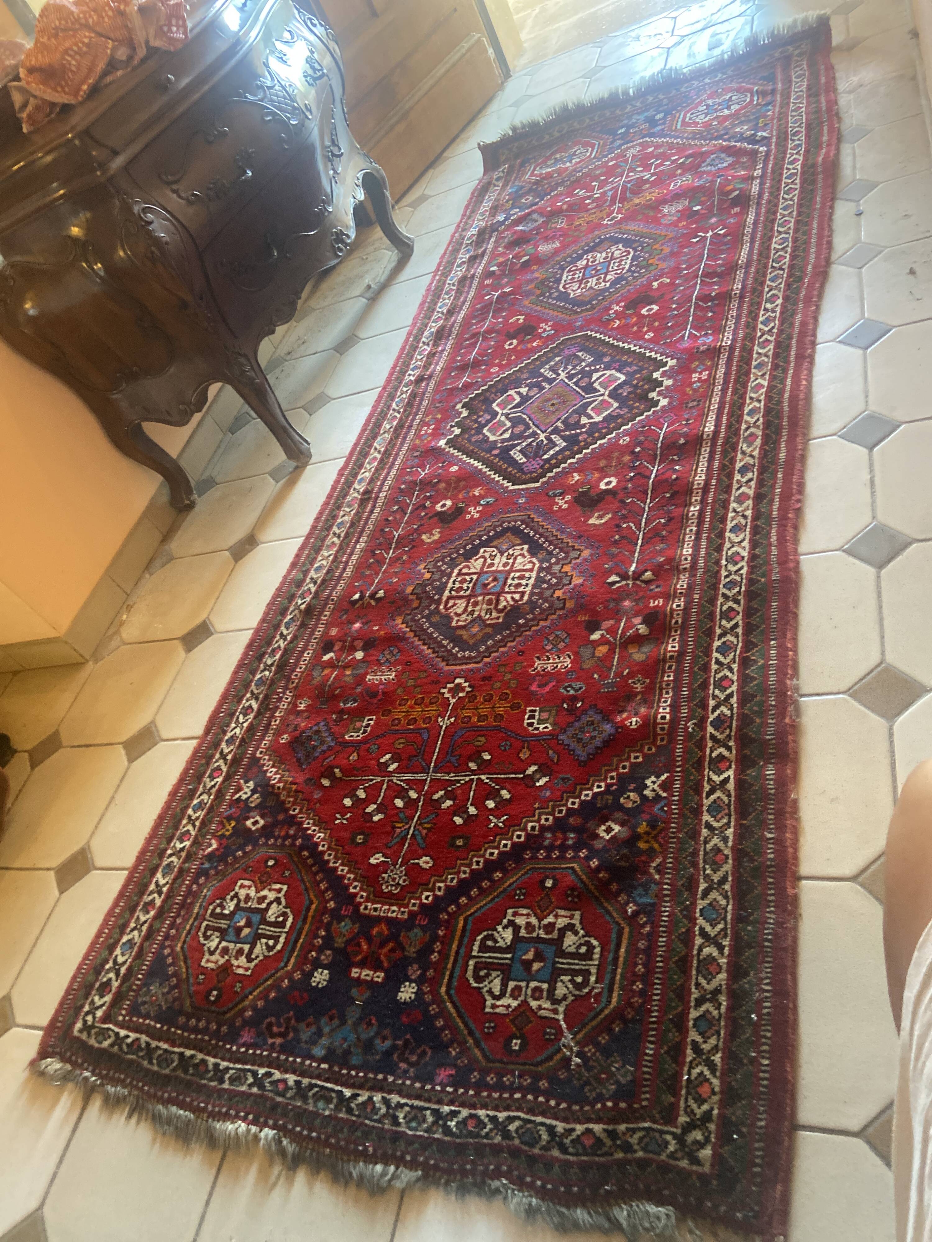 Large antique Oriental hallway carpet made of hand-knotted wool.