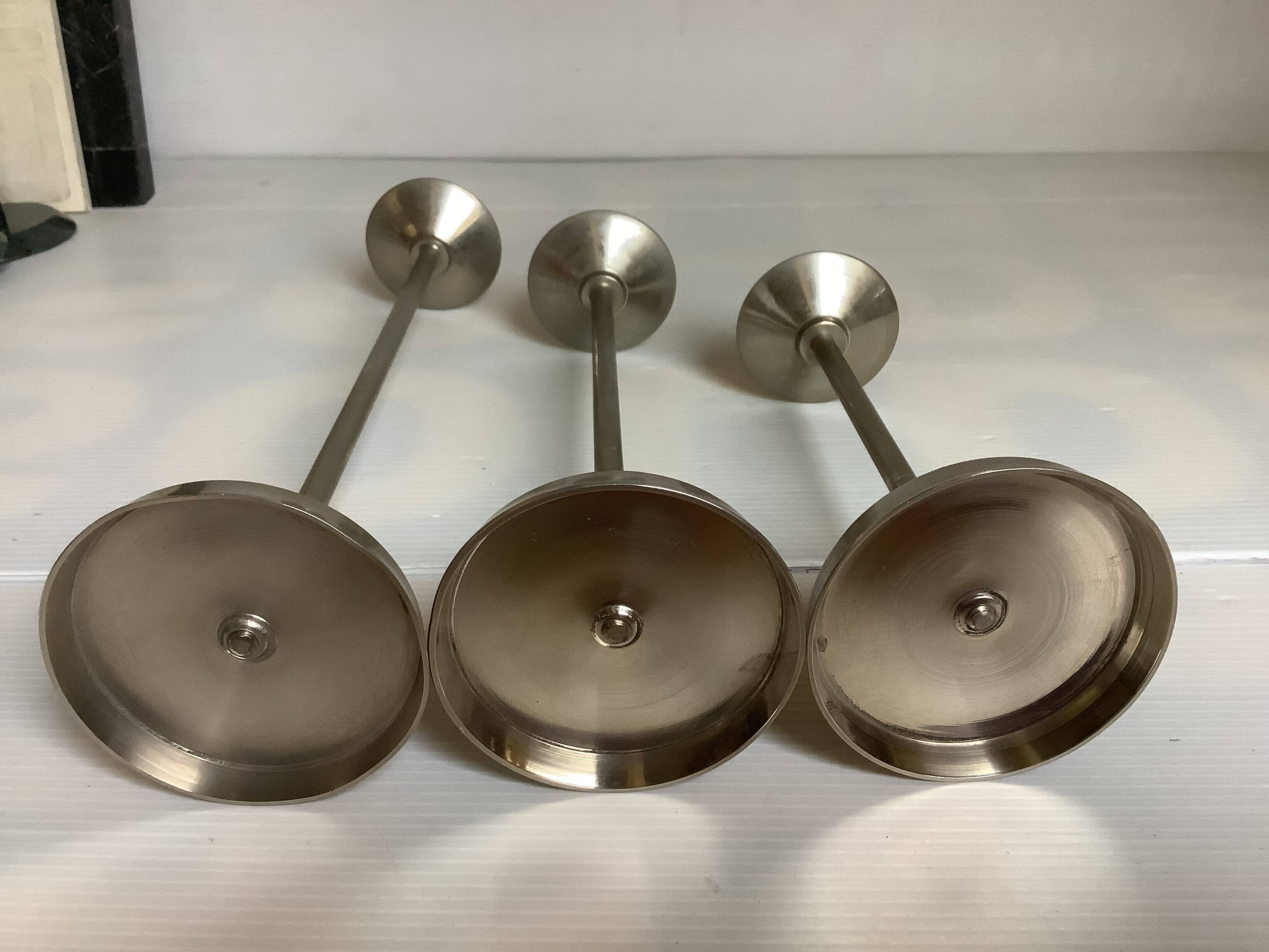 Trio of metal and wood candlesticks