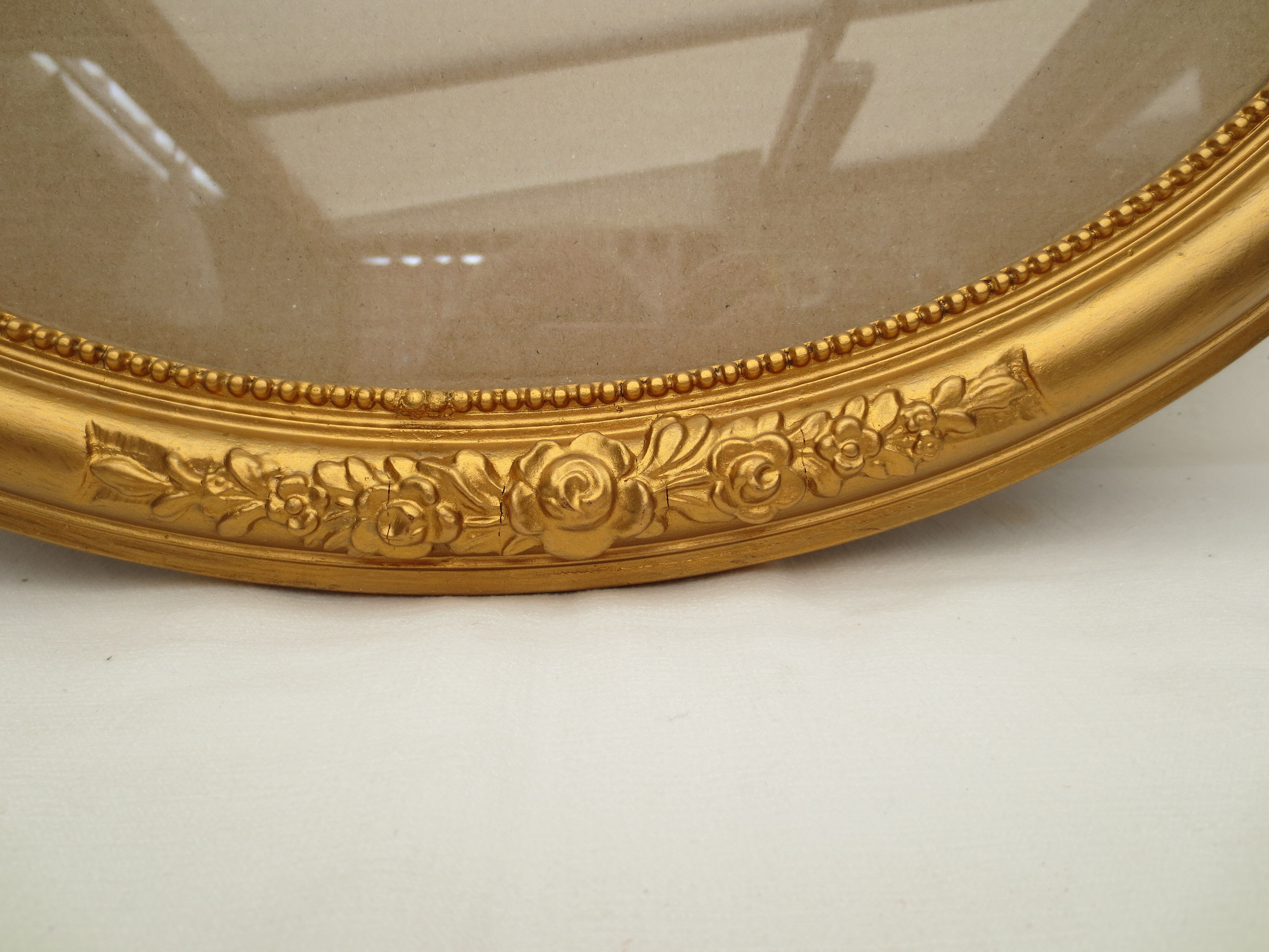 Large old oval gilded wooden frame and stucco decorations