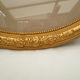 Large old oval gilded wooden frame and stucco decorations