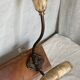 19th-century wall coat rack with 2 metal and horn hooks.