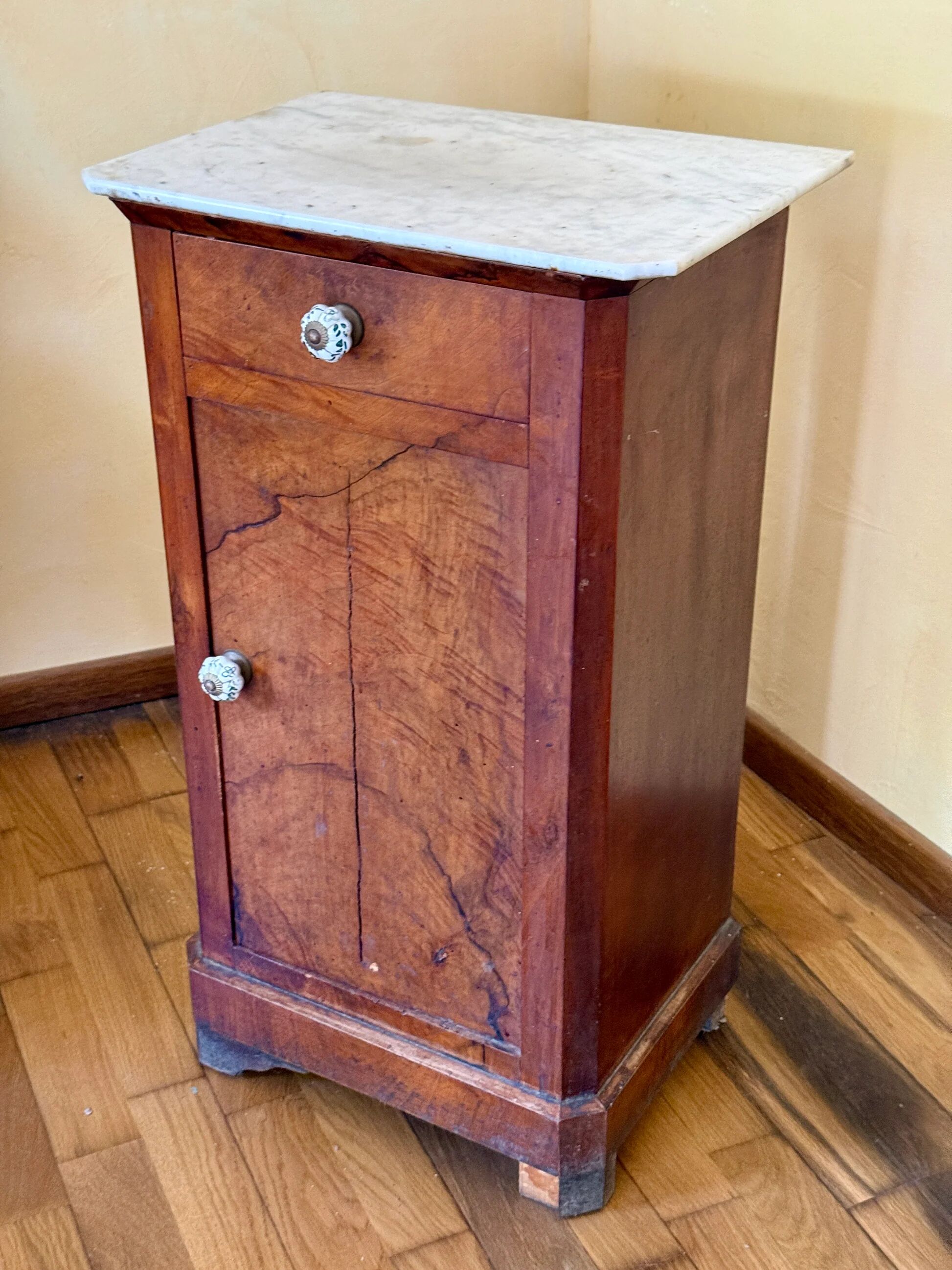 Wood and marble side table with ceramic handles.