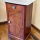 Wood and marble side table with ceramic handles.