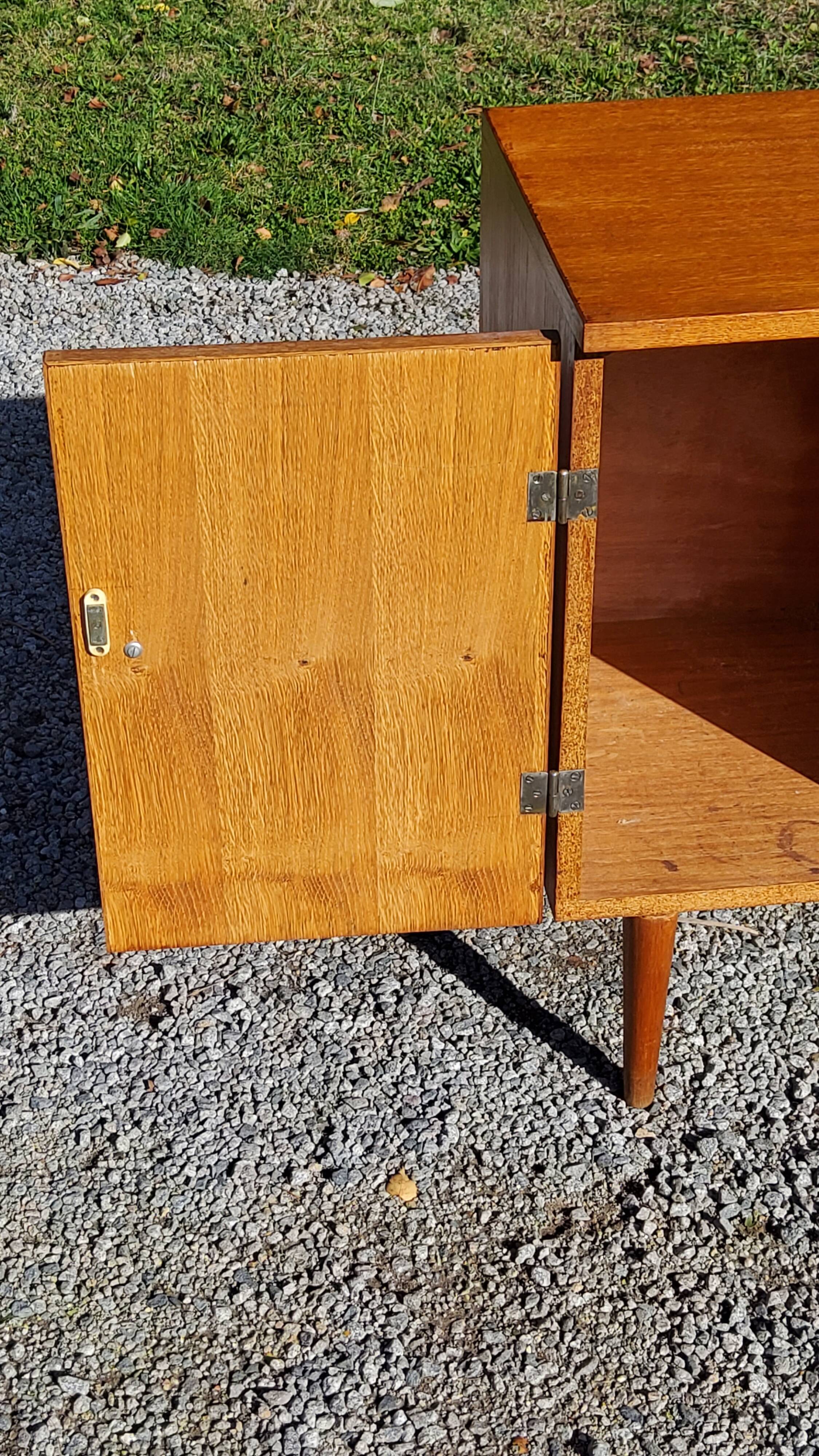 Vintage golden oak sideboard with conical legs from the 1950s