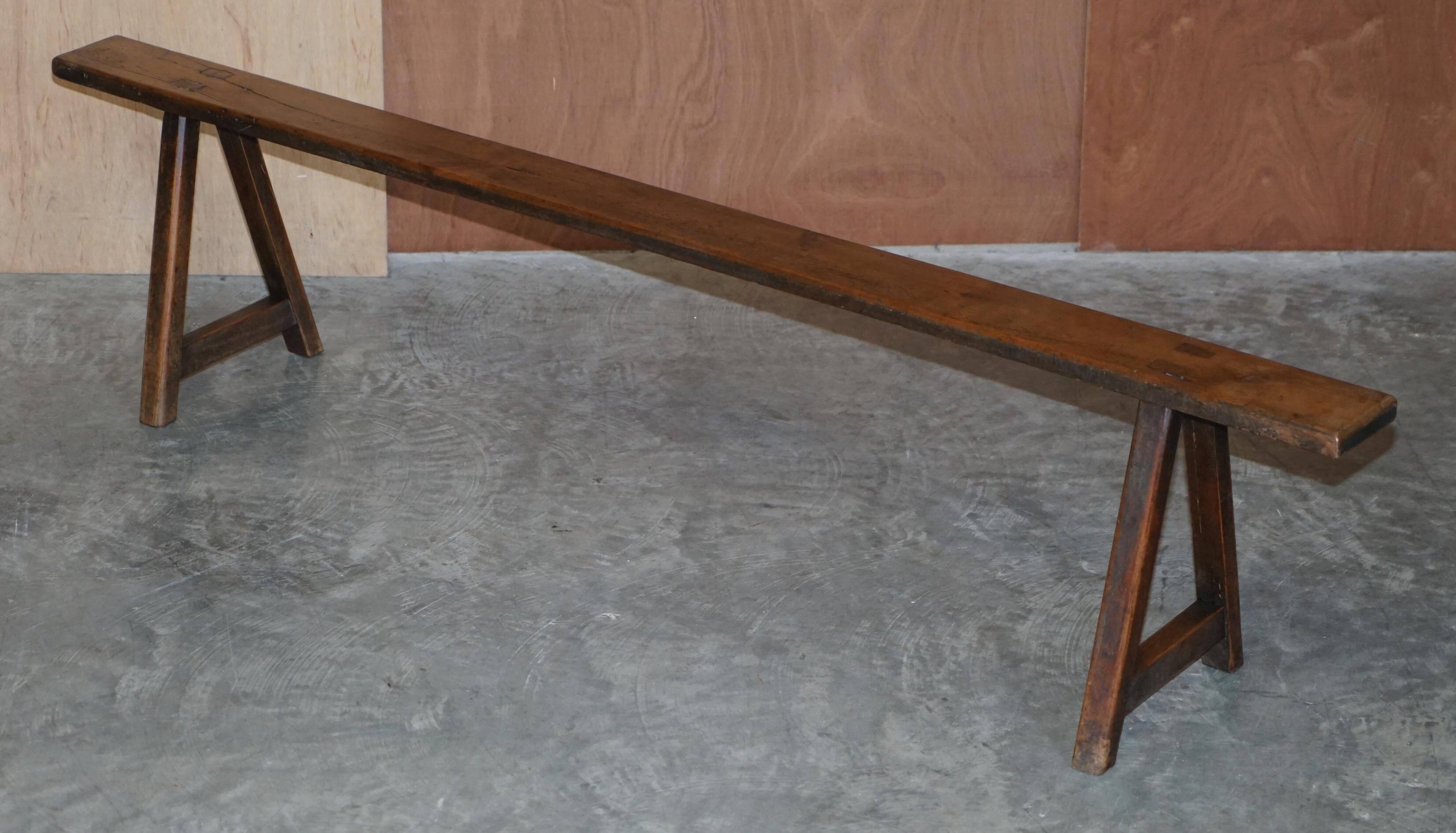 Pair of antique Victorian trestle benches in fruitwood.