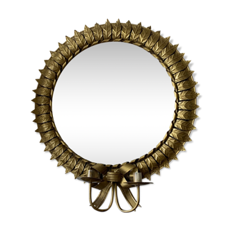 Round golden mirror with leaf and candlestick