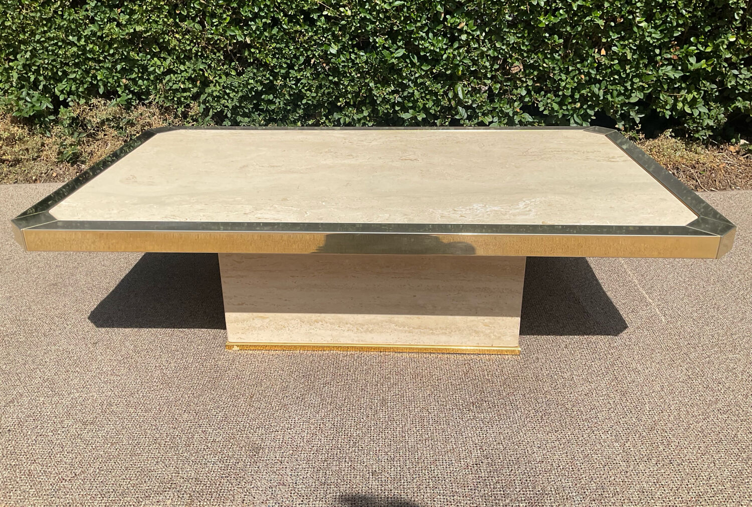 Vintage coffee table in travertine and brass.