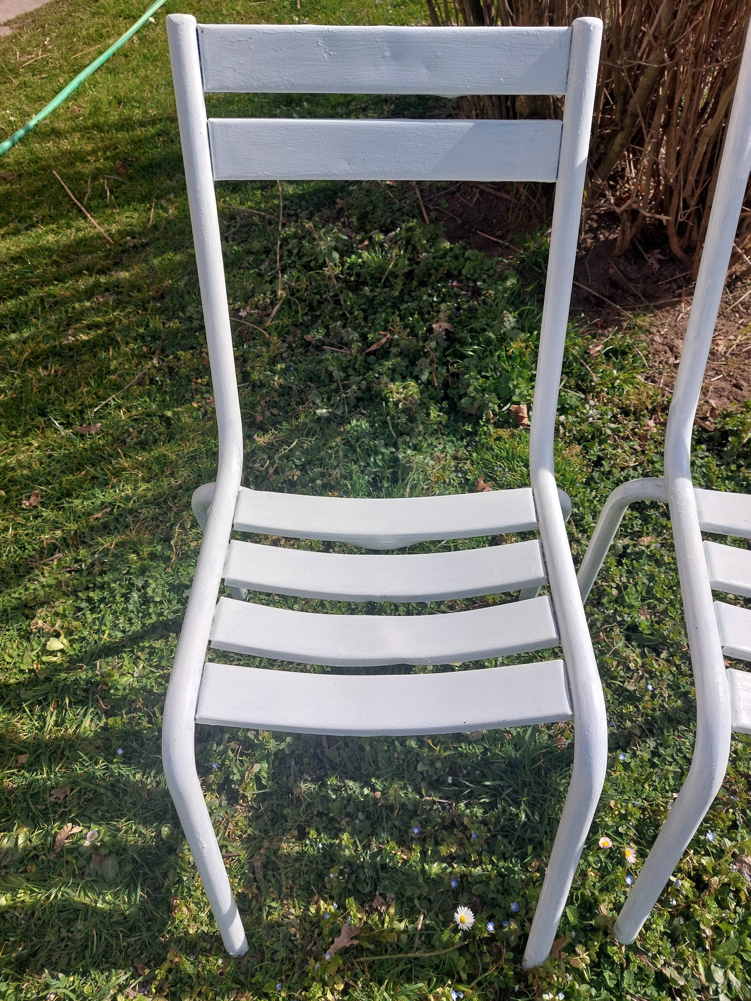 pair of white metal chairs, Tolix style