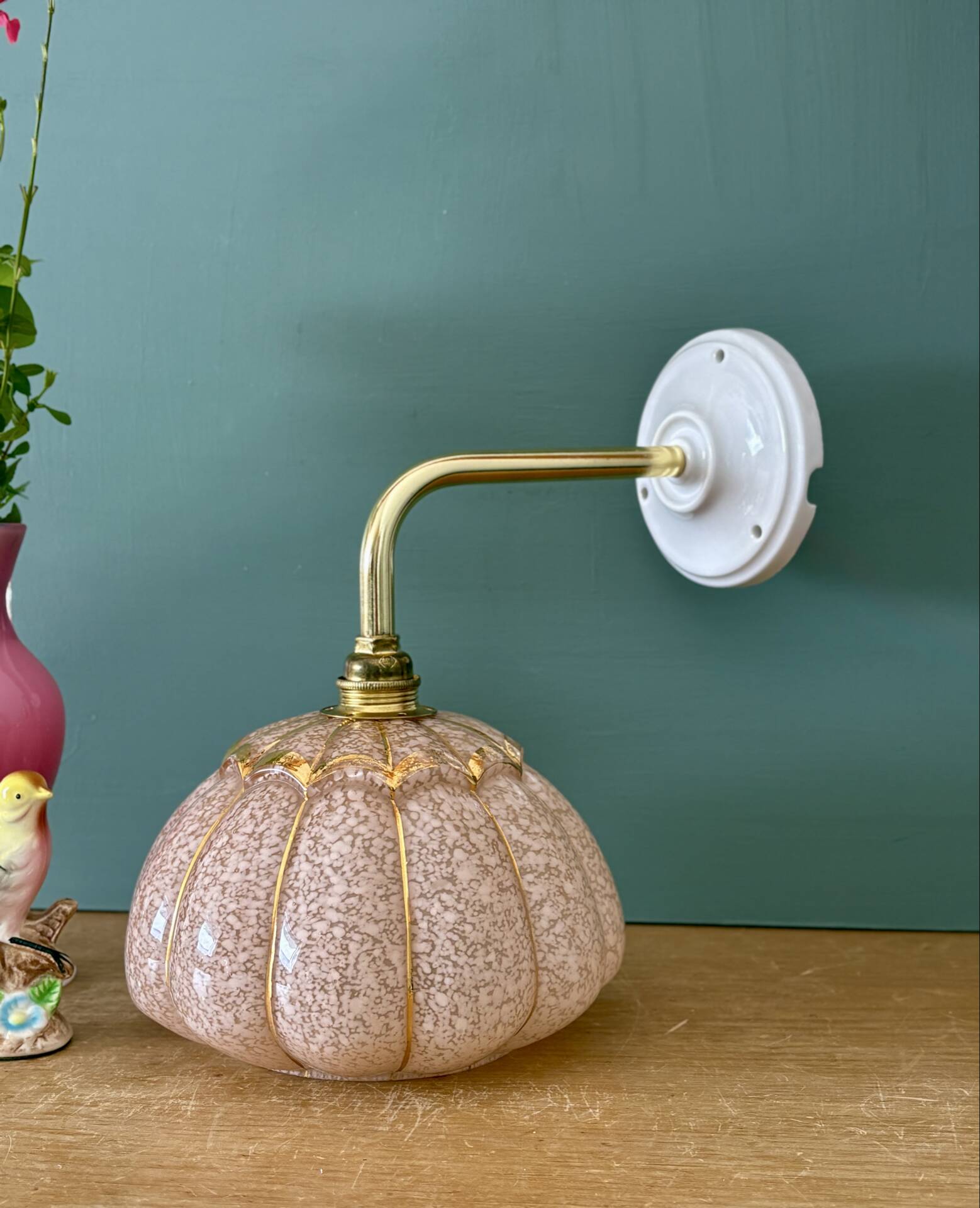 Vintage glass wall light with a pink and gold Clichy globe.