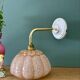 Vintage glass wall light with a pink and gold Clichy globe.