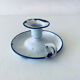Old candle holder in white enameled metal