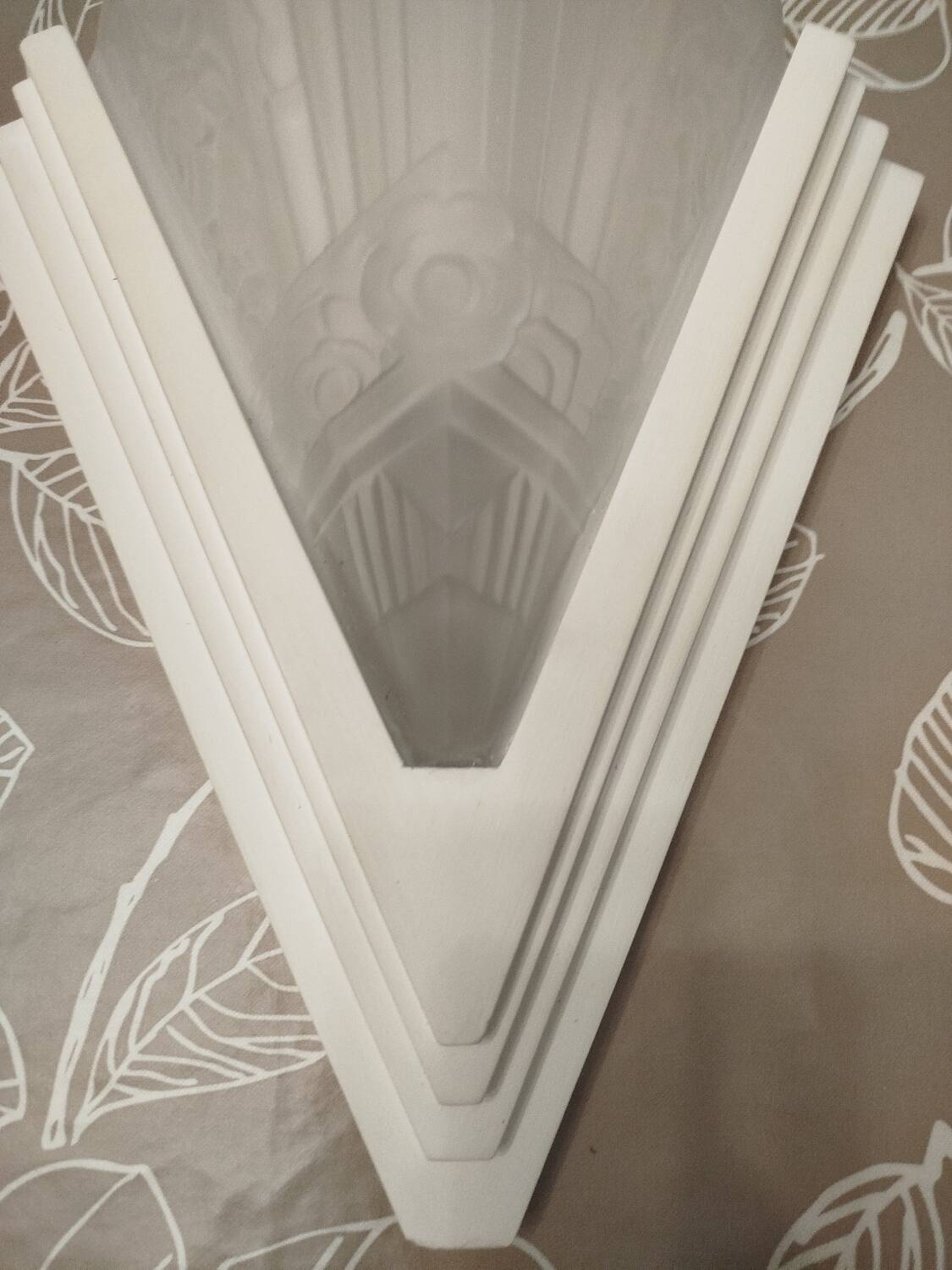 Pair of Art Deco wall sconces in plaster and pressed glass.