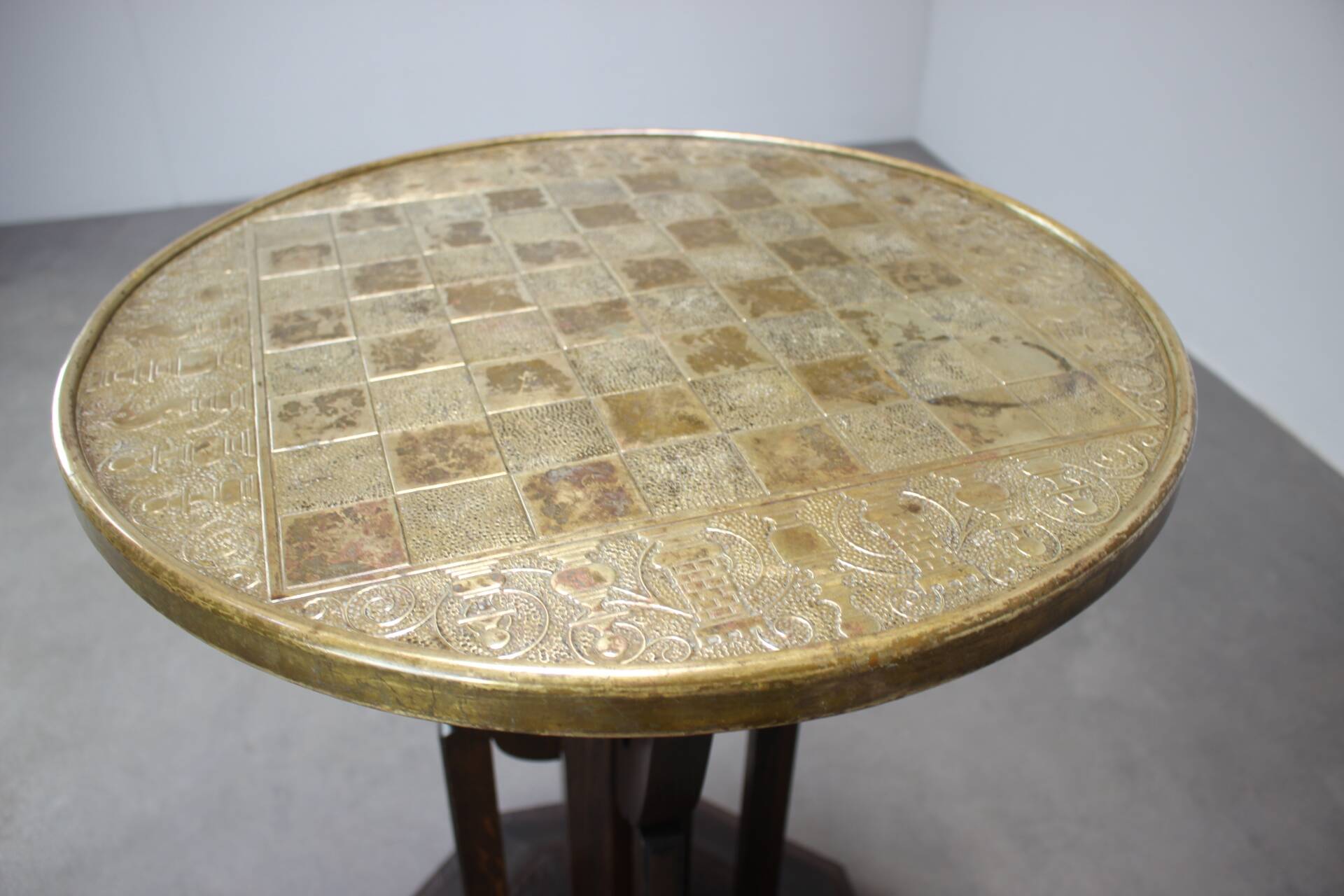 Art Deco chess table from the 1930s with a hand-decorated brass top and a stained oak base.