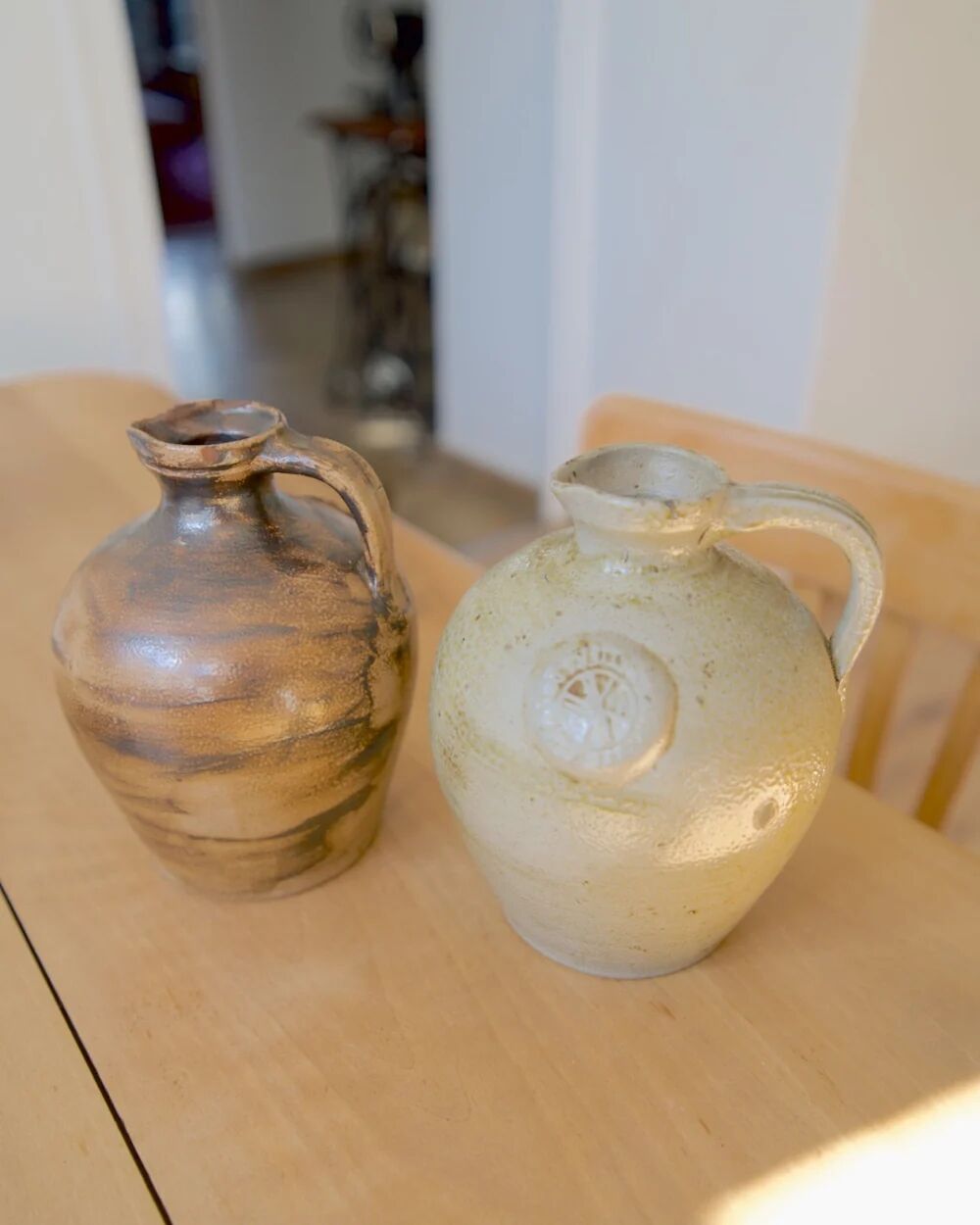 Duo of brown and cream ceramic jugs
