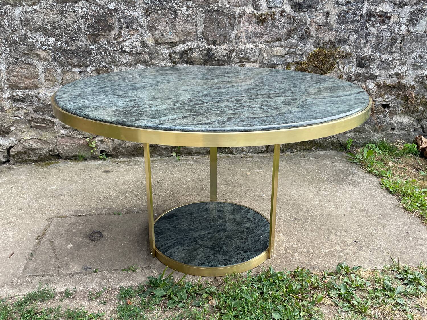 Round dining table with green marble and solid brass.
