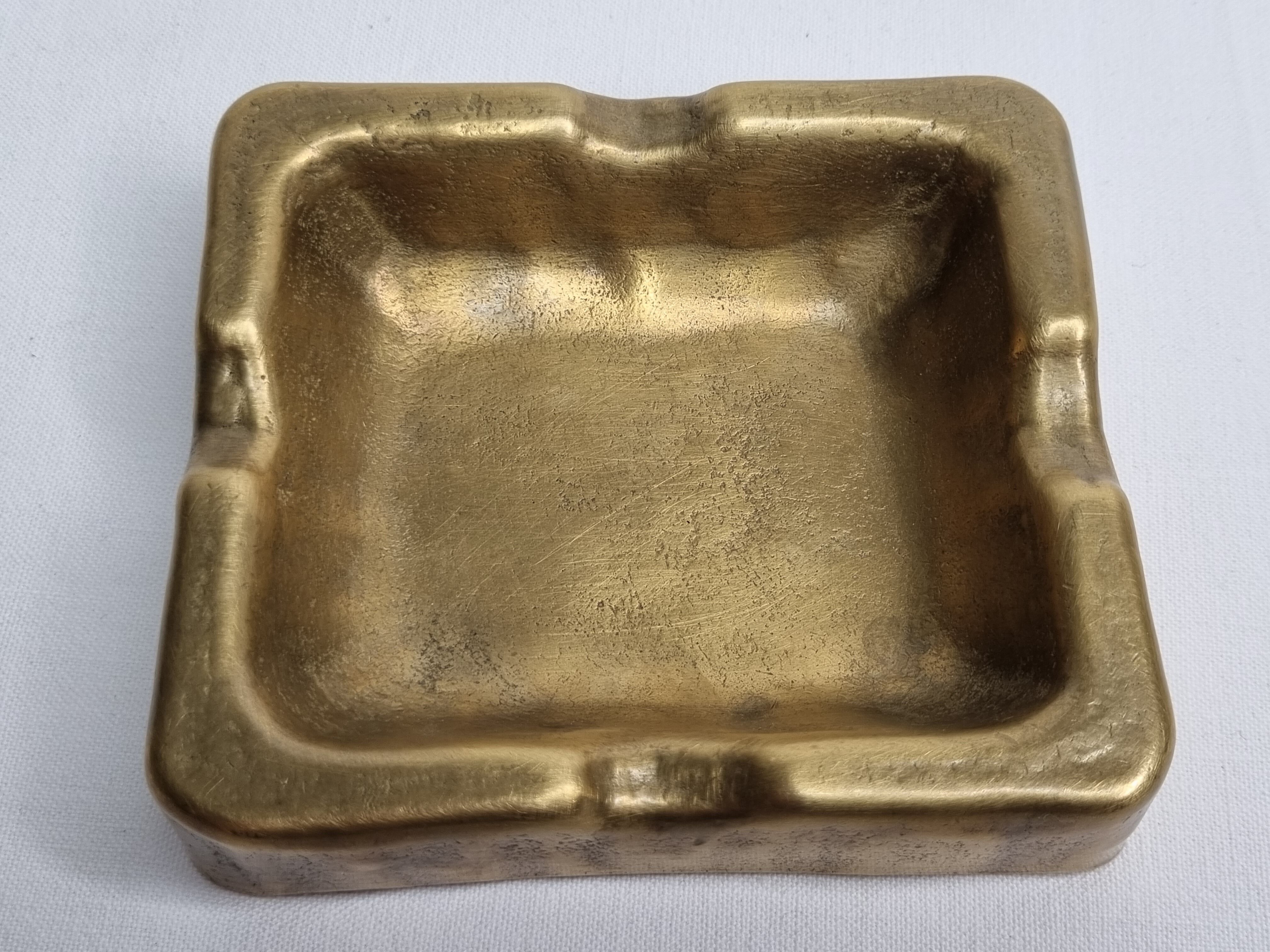 Empty pocket brutalist-inspired ashtray in gilded bronze