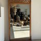 Very large freestanding teak mirror with an openwork carved pediment, Indonesia.