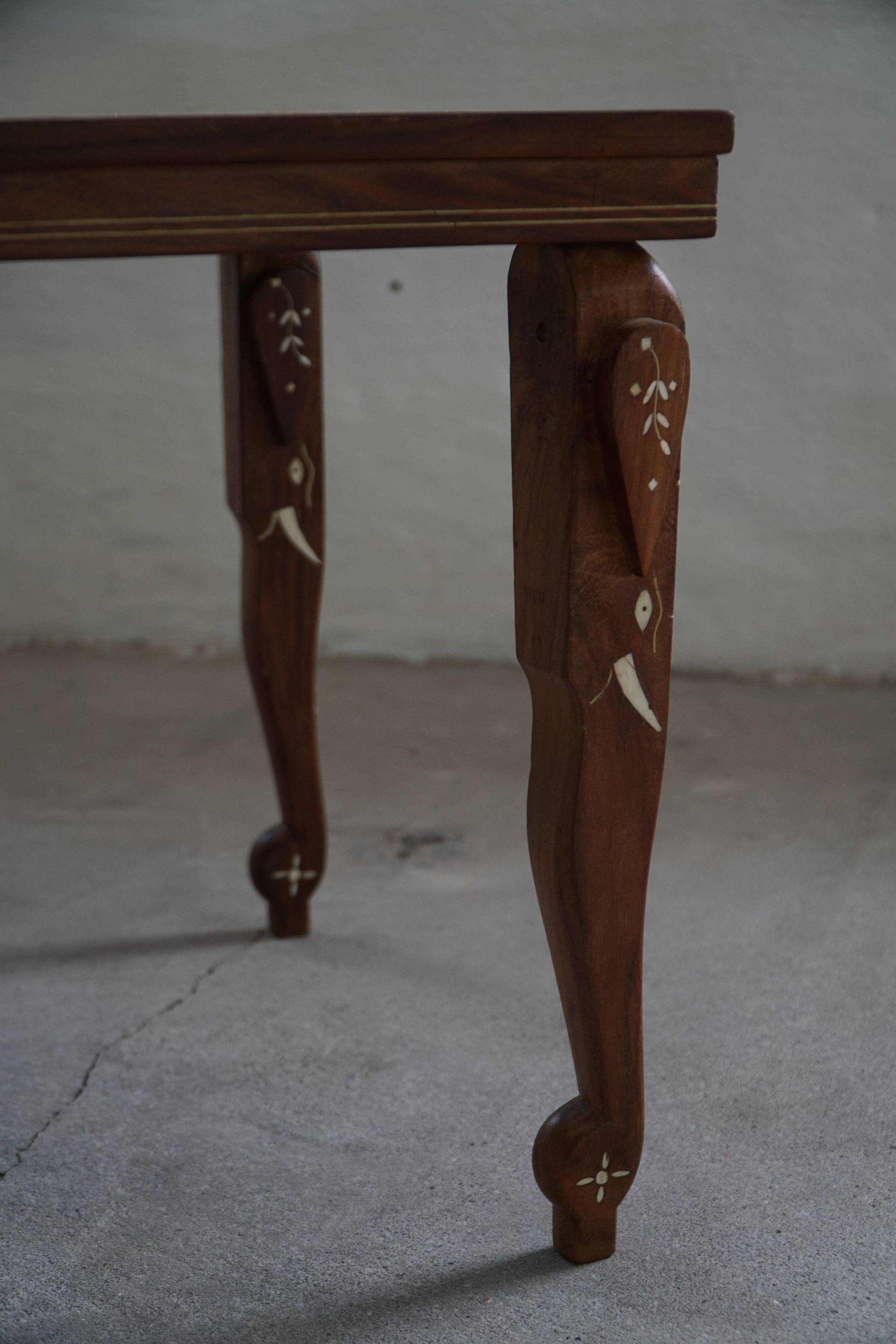 Vintage Indian teak coffee table inlaid with elephant motifs, mid-20th century.