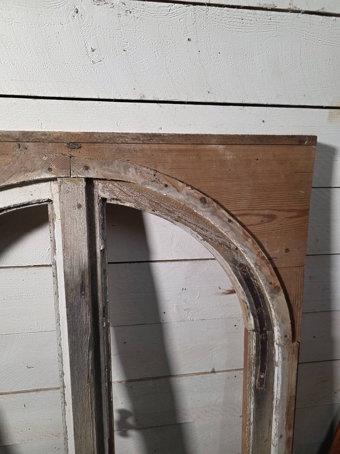 Old arched window made of fir wood