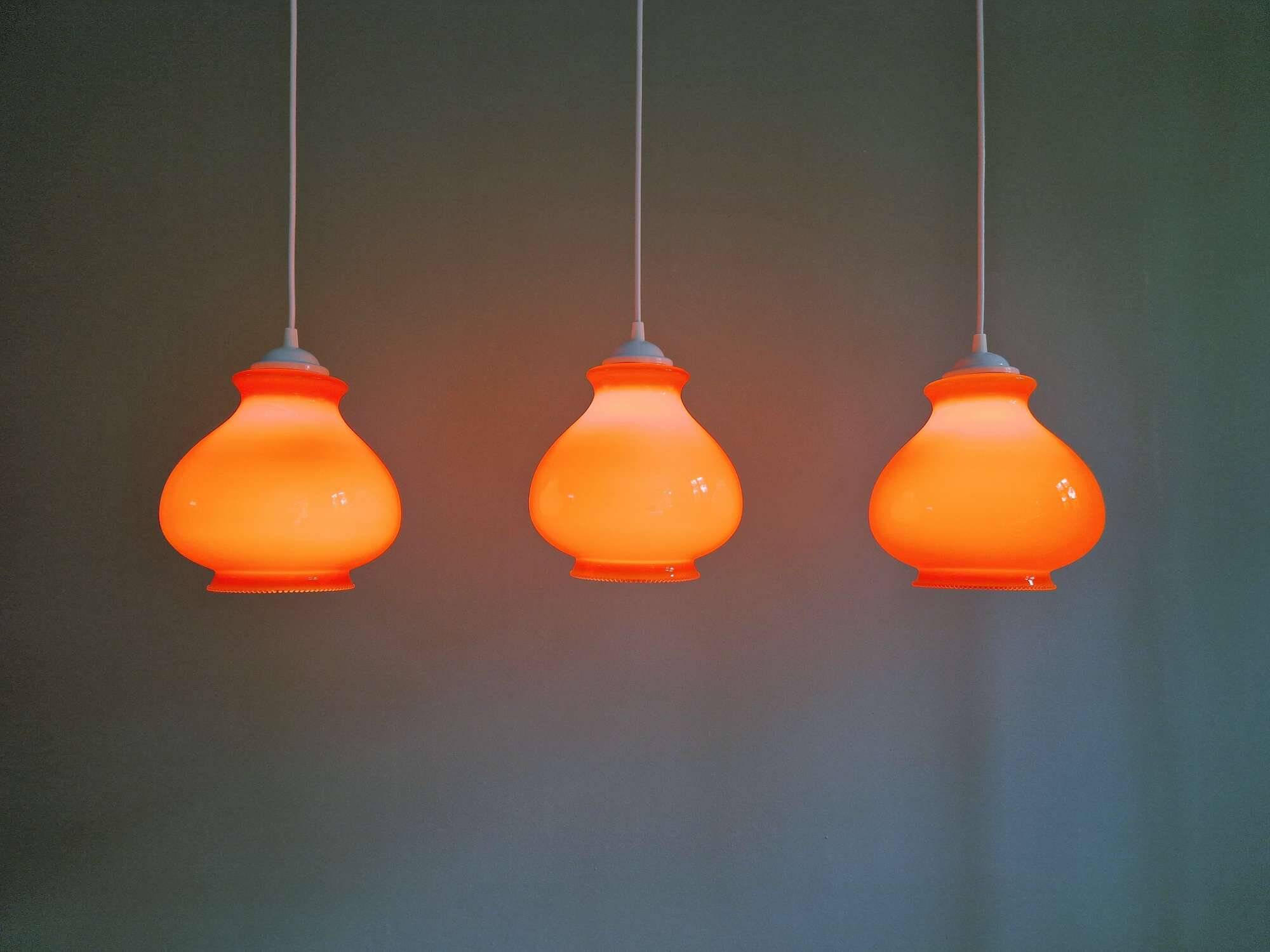 Trio of vintage orange opaline pendant lights, 1960-70