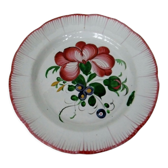 Old earthenware plate of the East Strasbourg decorated with flowers