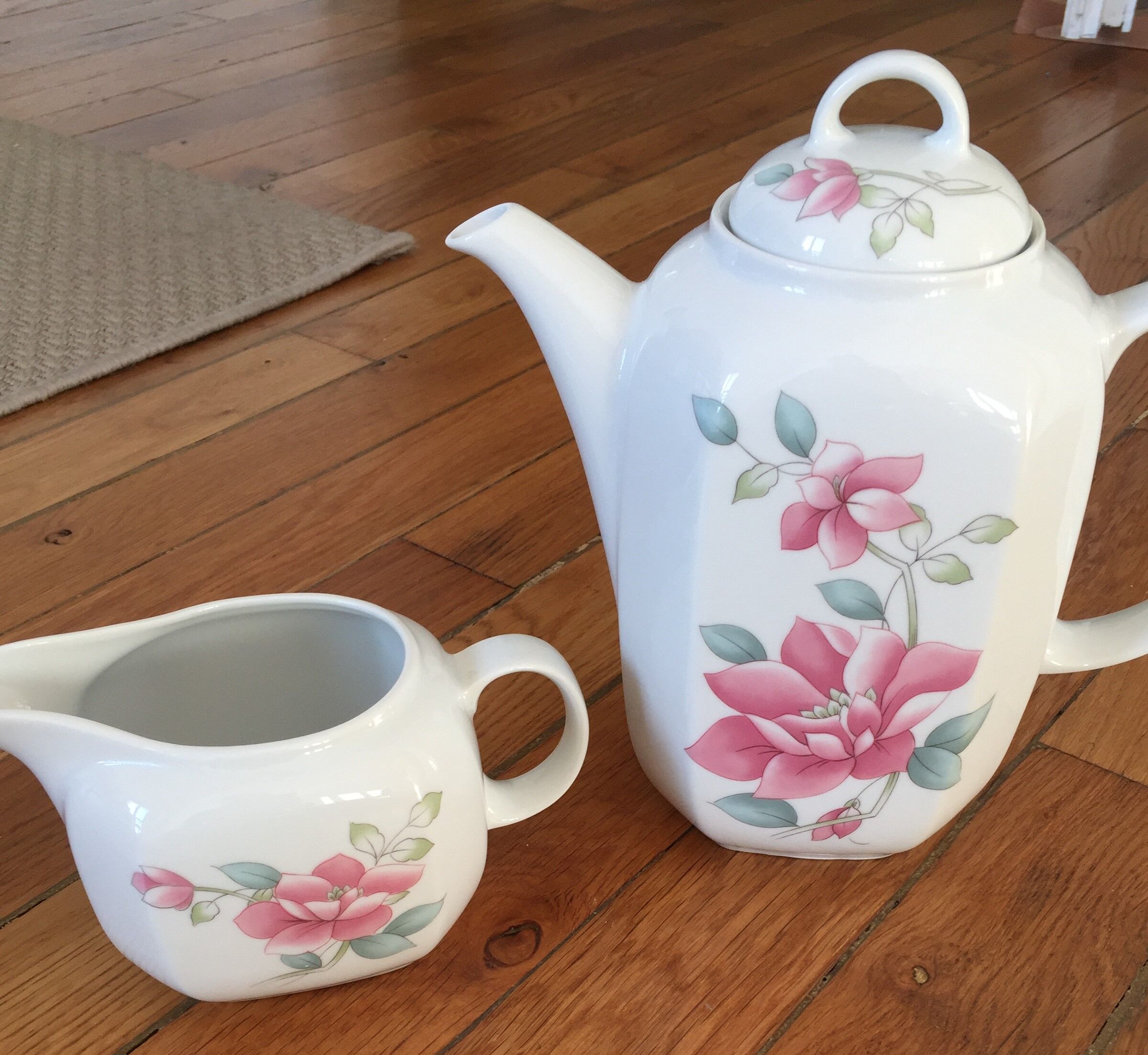 Vintage porcelain coffee or teapot with milk jug