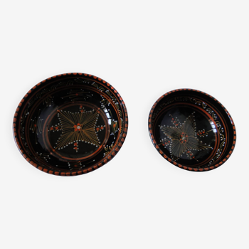 Pair of cups different sizes black background graphic decor