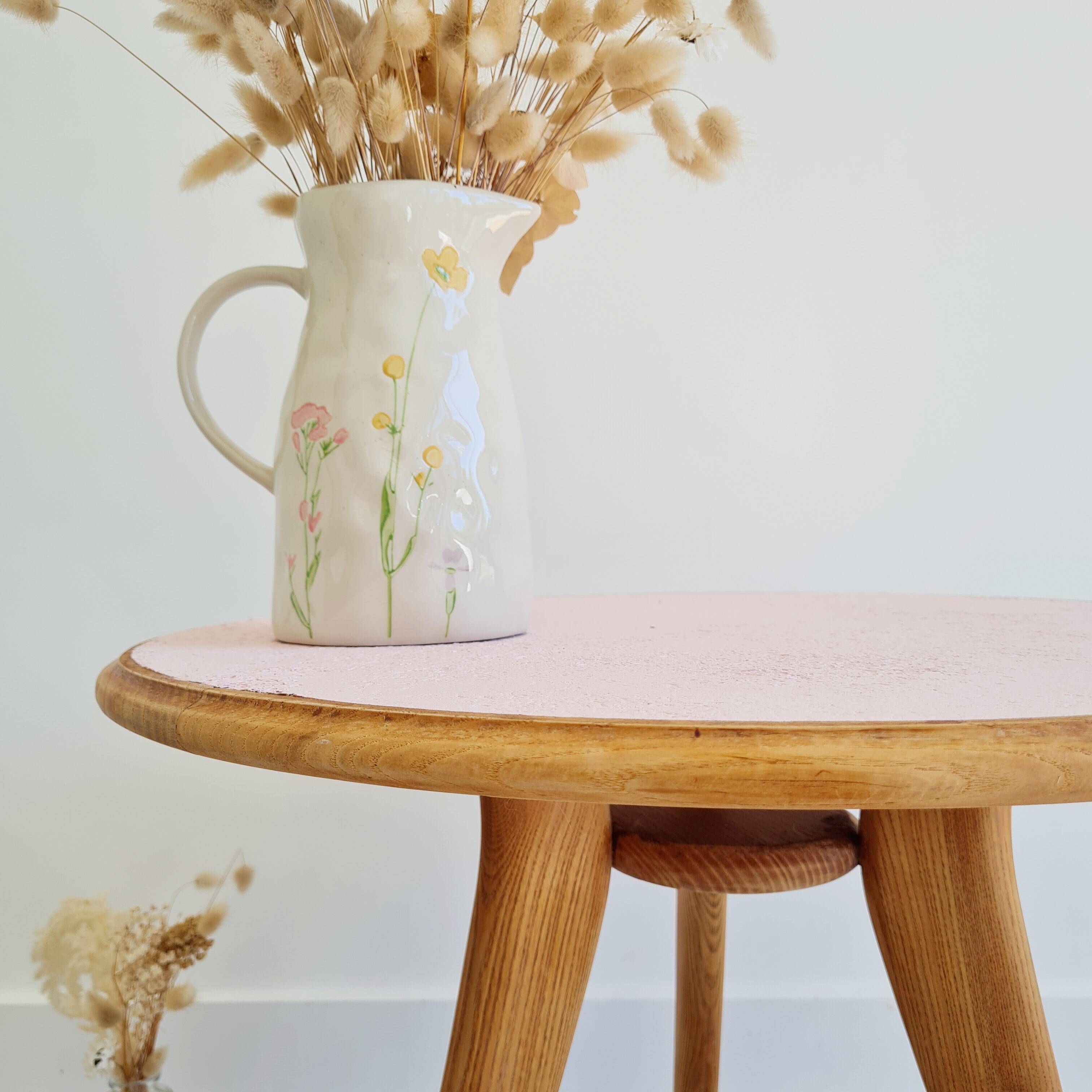 Pink round top tripod coffee table