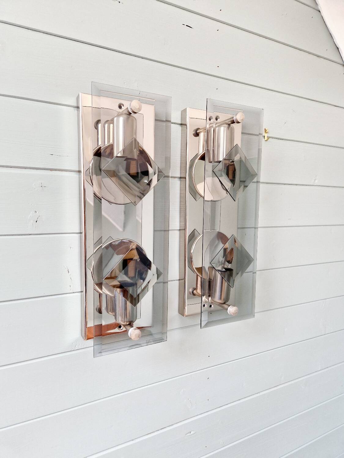 Pair of chrome metal and smoked glass wall sconces, 1970s.
