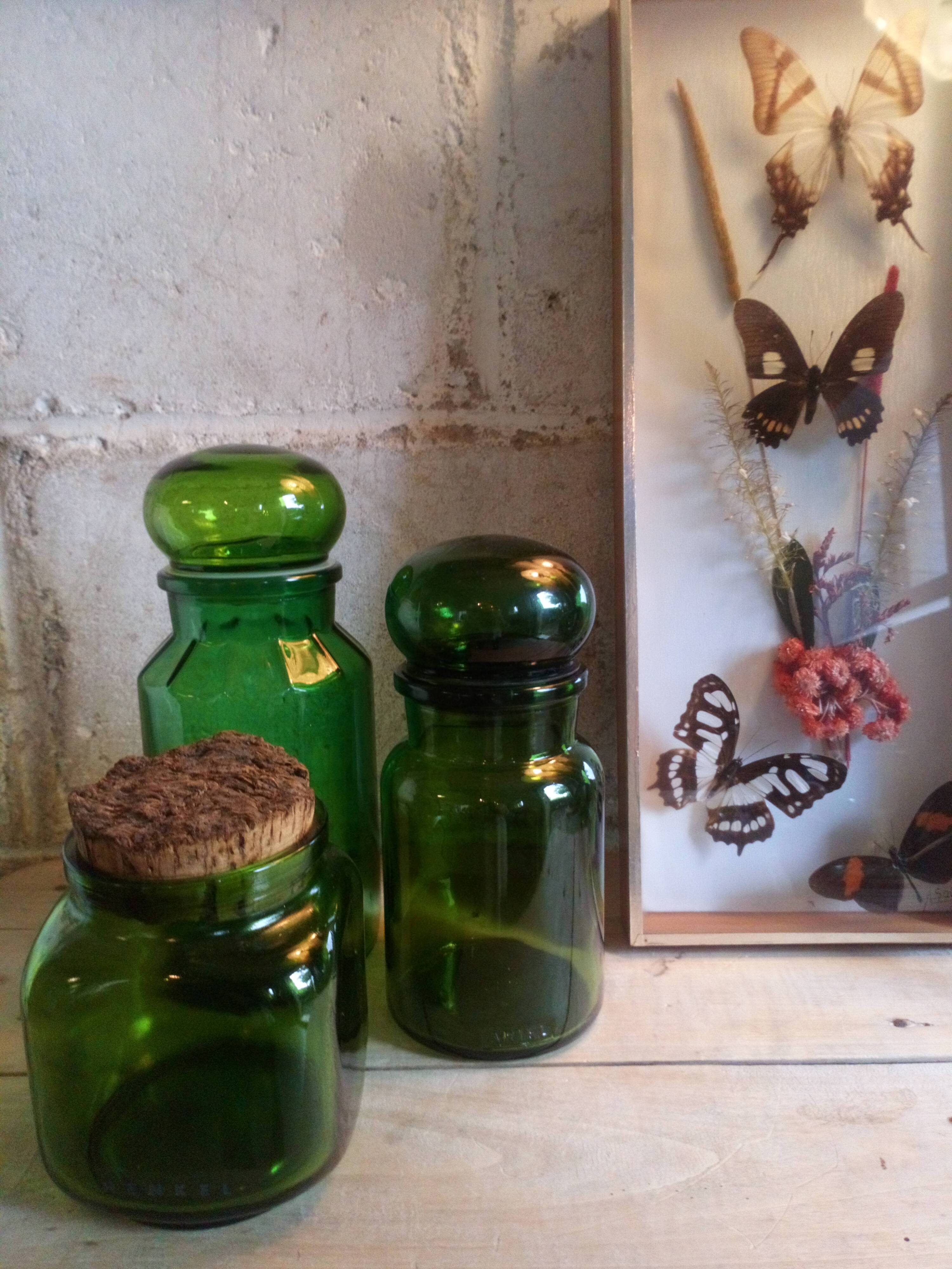 Trio of green glass apothecary bottles