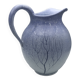 Blue glazed terracotta pitcher with hand-painted decoration, signed