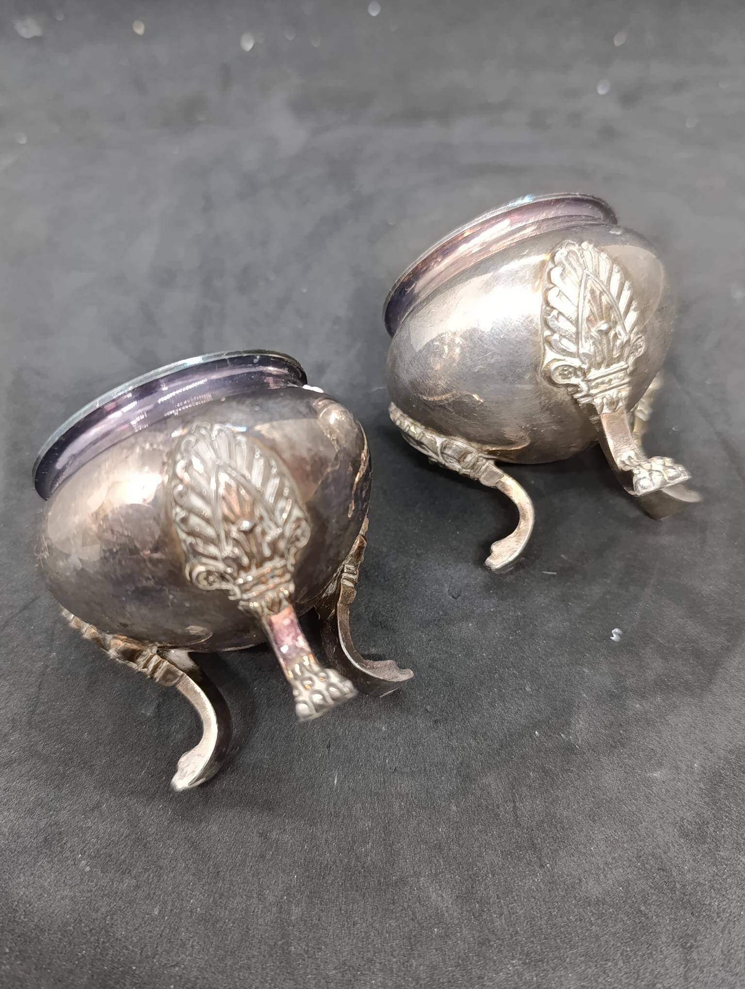Pair of silver metal salt cellars with lion decor base
